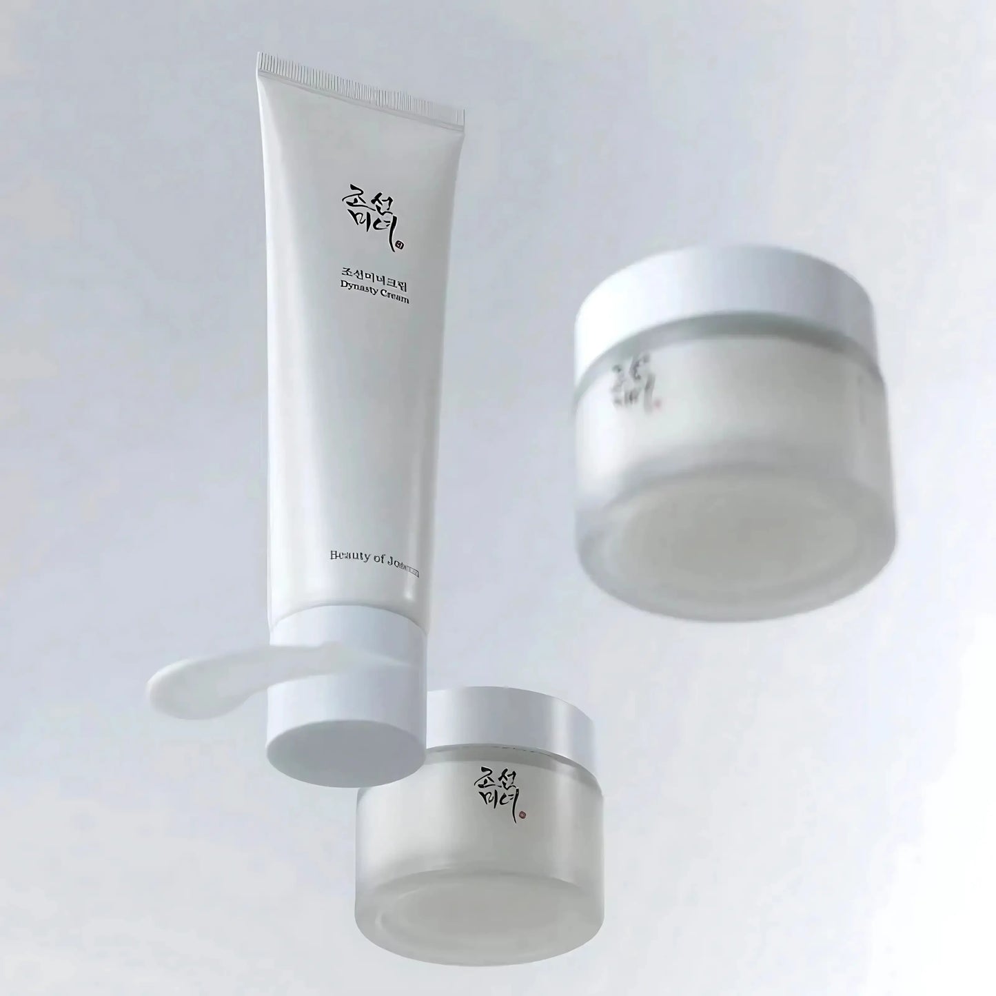 Beauty of Joseon Dynasty Cream 100ml – foto do frasco ao lado do boião, captada com luz azul clara que transmite frescura e hidratação, cosmética coreana e skincare k-beauty Portugal