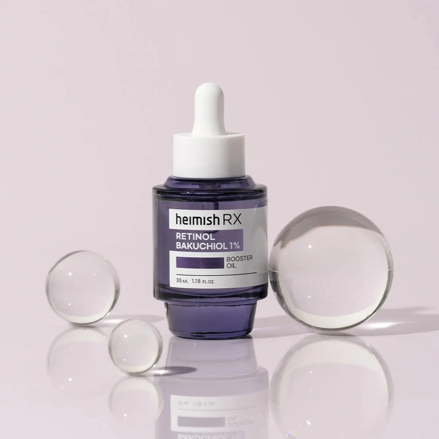 Heimish RX Retinol Bakuchiol Booster Oil 35ml, óleo coreano facial anti-envelhecimento com retinol e bakuchiol, melhora firmeza e elasticidade, frasco em pé com esferas de vidro transparentes ao redor, fundo lilás, cosmética coreana skincare k-beauty Portugal.
