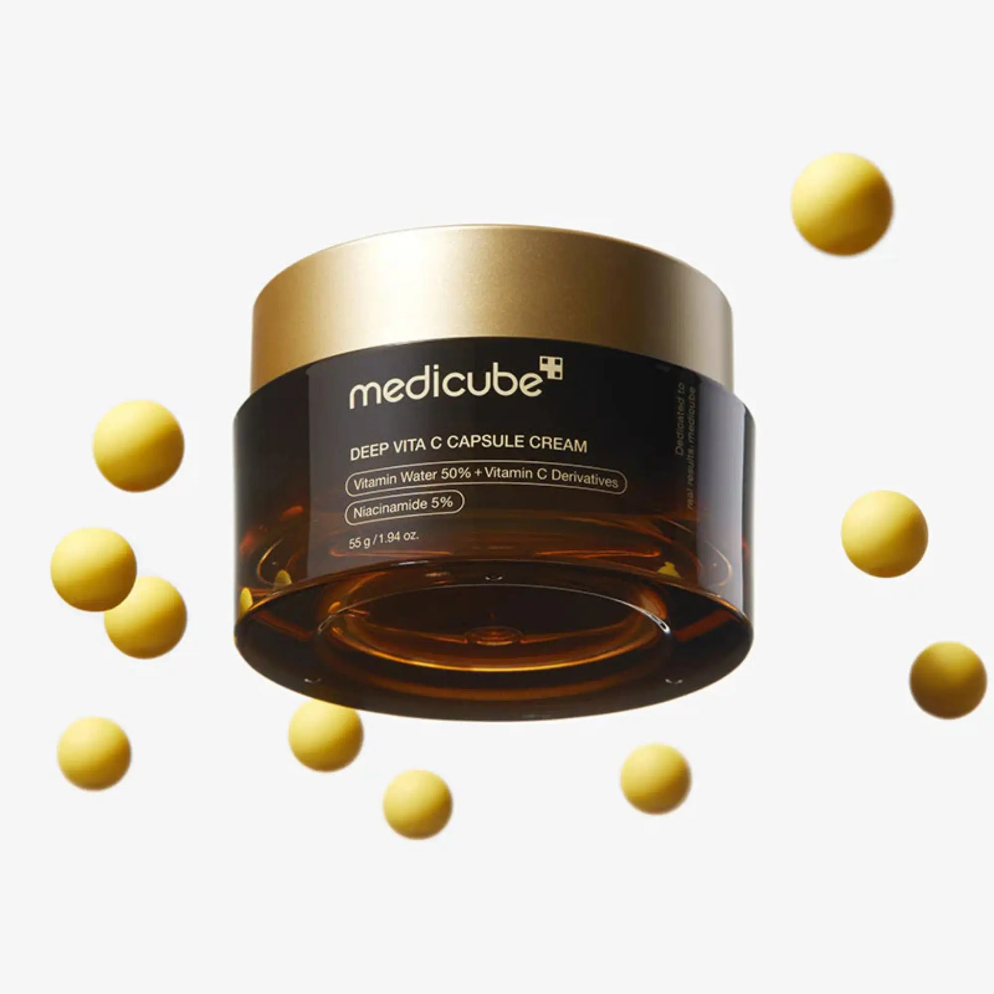 Medicube Deep Vita C Capsule Cream 55g, creme coreano antioxidante com vitamina C pura encapsulada para luminosidade, redução de manchas e pele uniforme, frasco fechado com cápsulas douradas a flutuar ao redor sobre fundo branco, cosmética coreana skincare k-beauty Portugal.