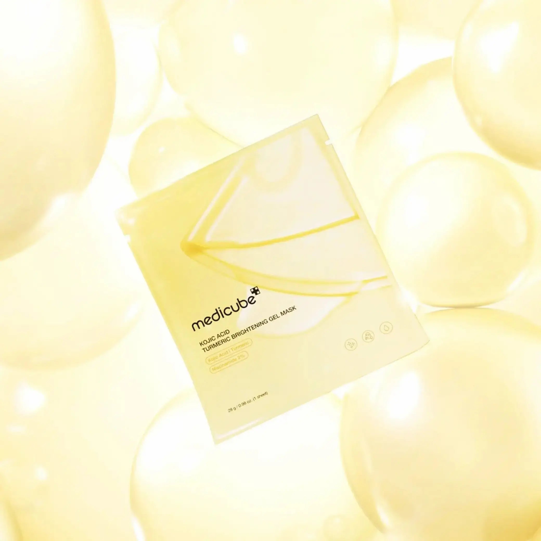 Kojic Acid Turmeric Brightening Gel Mask da Medicube em fundo com bolhas amarelas