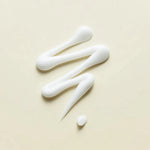 Wonder Releaf Centella Eye Cream Unscented da Purito Seoul textura do creme em zigzag em fundo bege